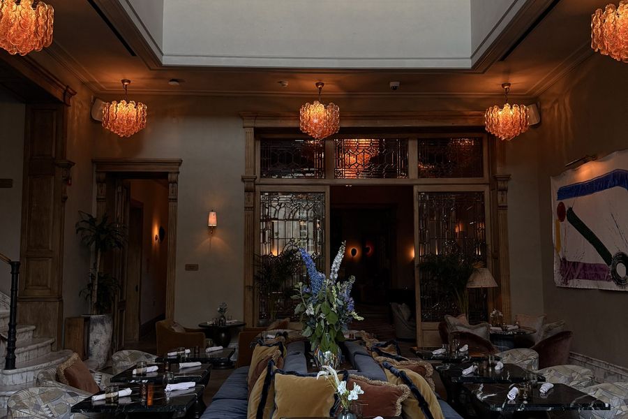 Upscale lounge seating with patterned chairs and warm sconces