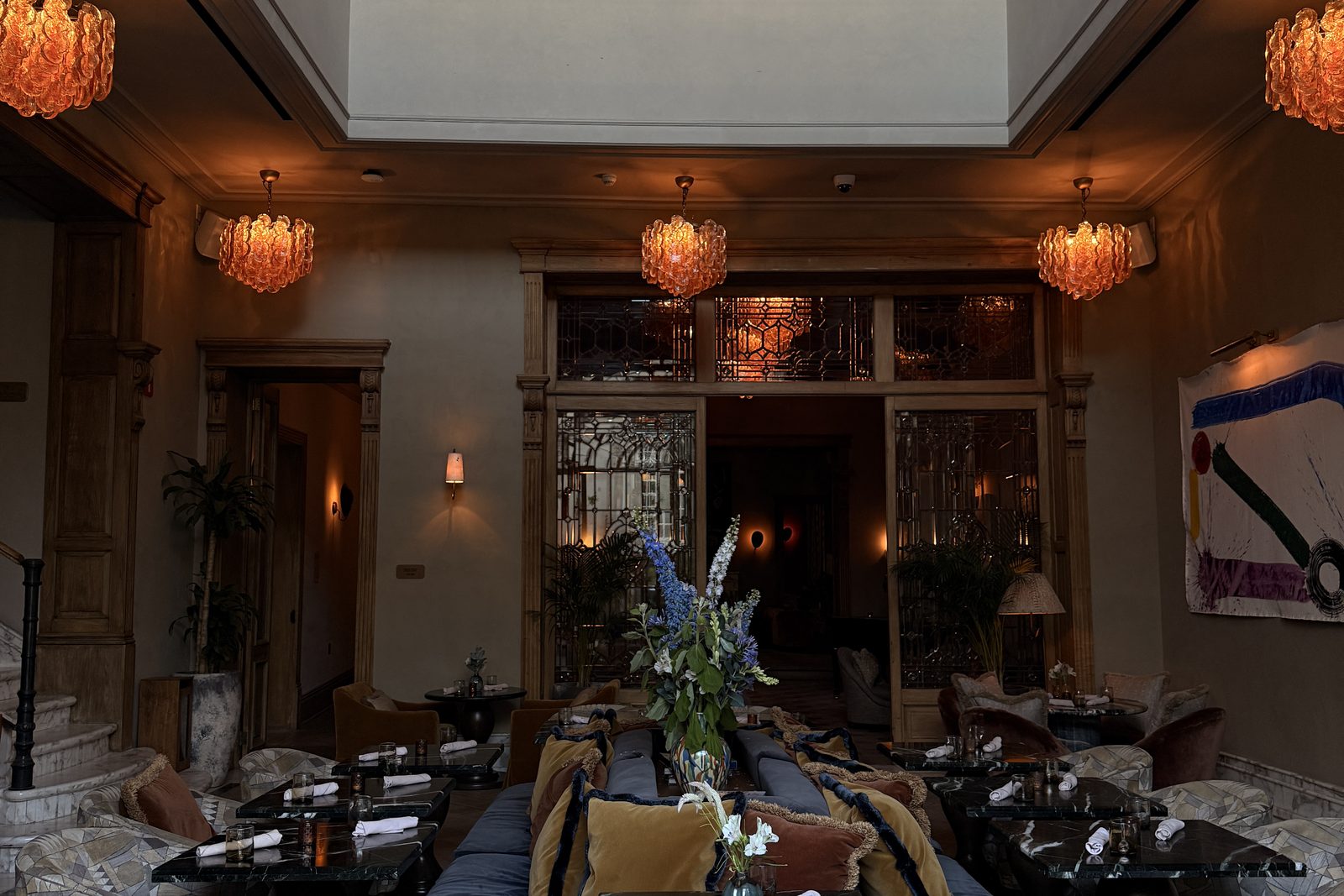 Upscale lounge seating with patterned chairs and warm sconces