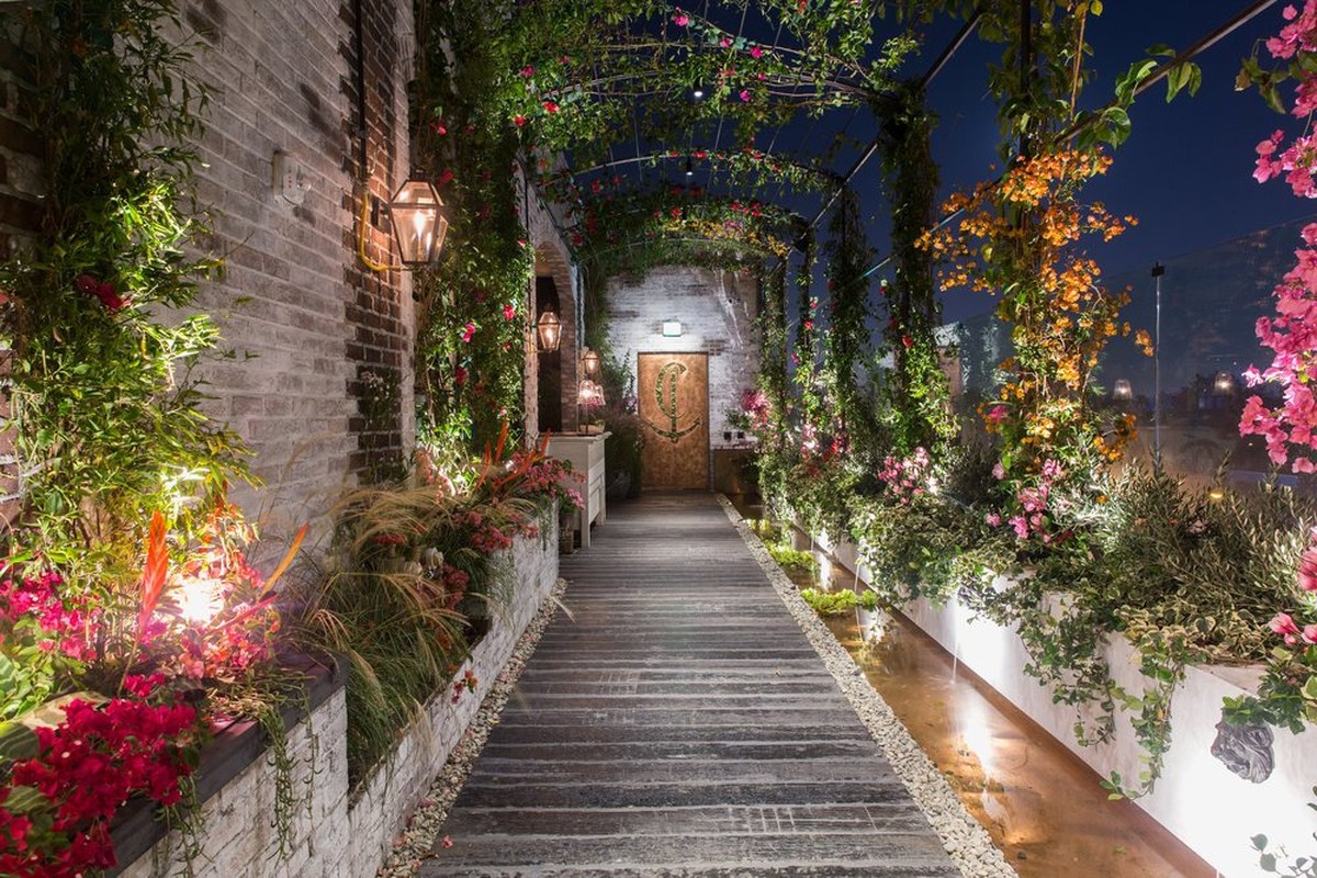 Catch LA rooftop arrivals walkway with vine-covered arches and signature Catch C door, West Hollywood