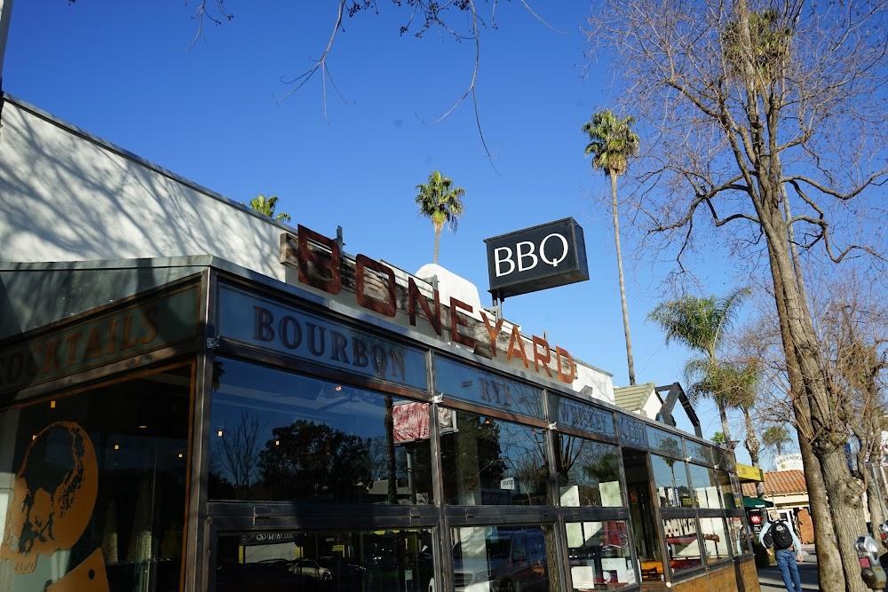 Boneyard Bistro Ventura Blvd exterior with BONEYARD BBQ signage and palm trees, Sherman Oaks