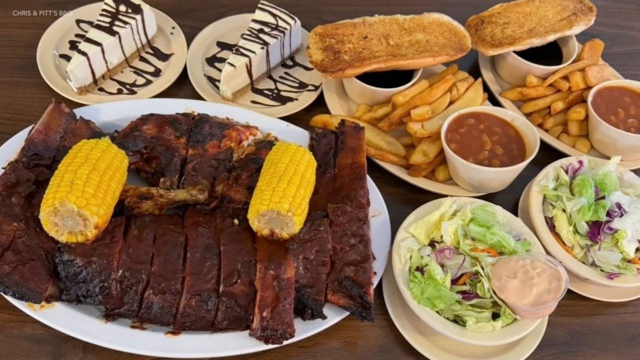 Chris & Pitts BBQ branded platter of ribs, chicken, corn, fries and sides
