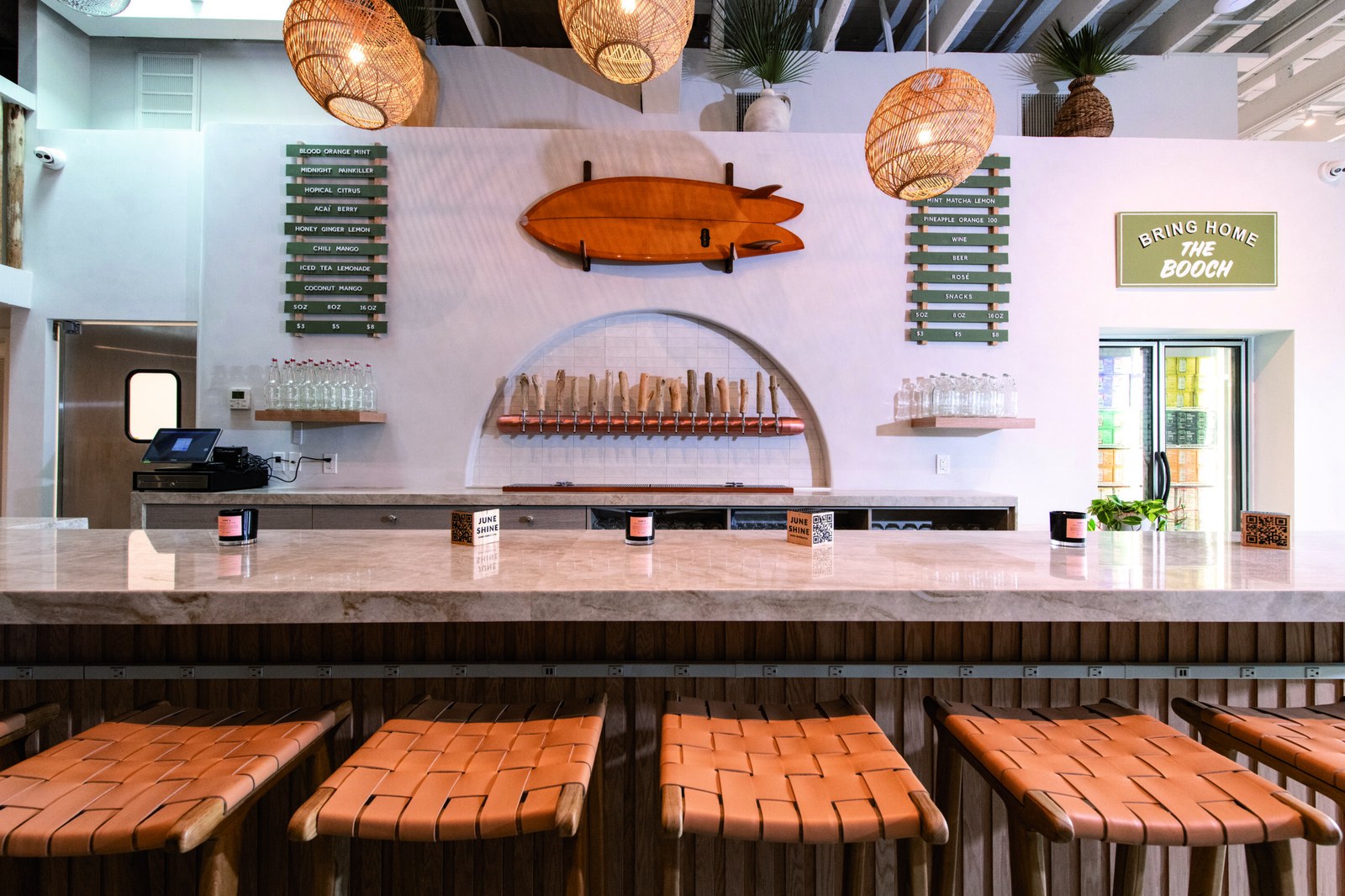 JuneShine Santa Monica tasting room bar with taps and surfboard decor