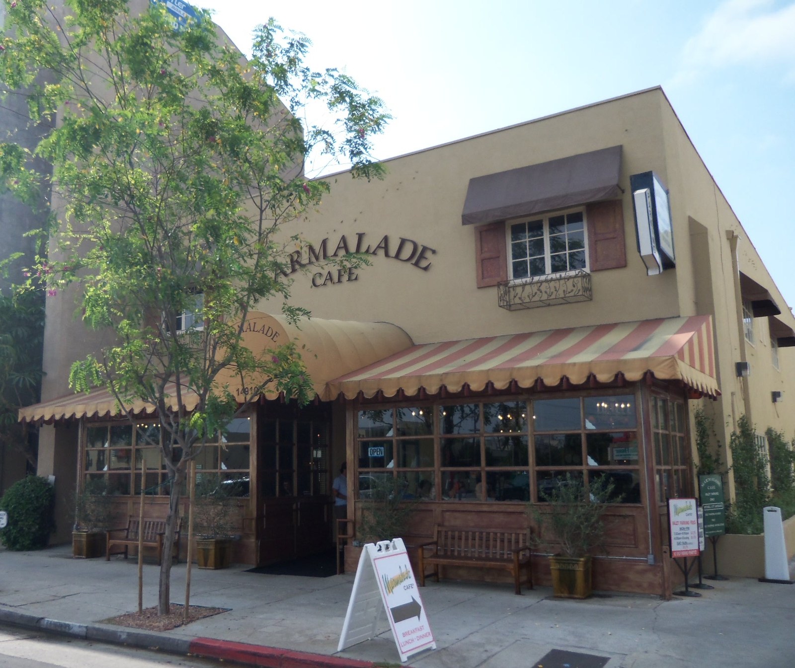 Marmalade Cafe storefront with striped awning and sidewalk seating