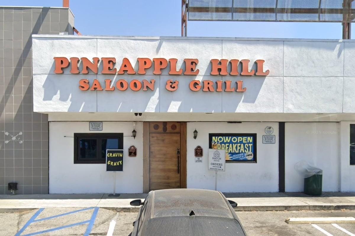 Pineapple Hill Saloon & Grill white stucco exterior with orange dimensional signage on Van Nuys Blvd, Sherman Oaks