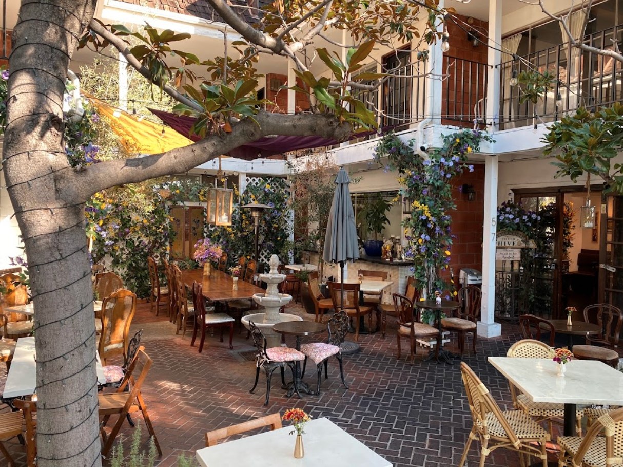 Queen Violet courtyard patio with vines and brick flooring, West Hollywood