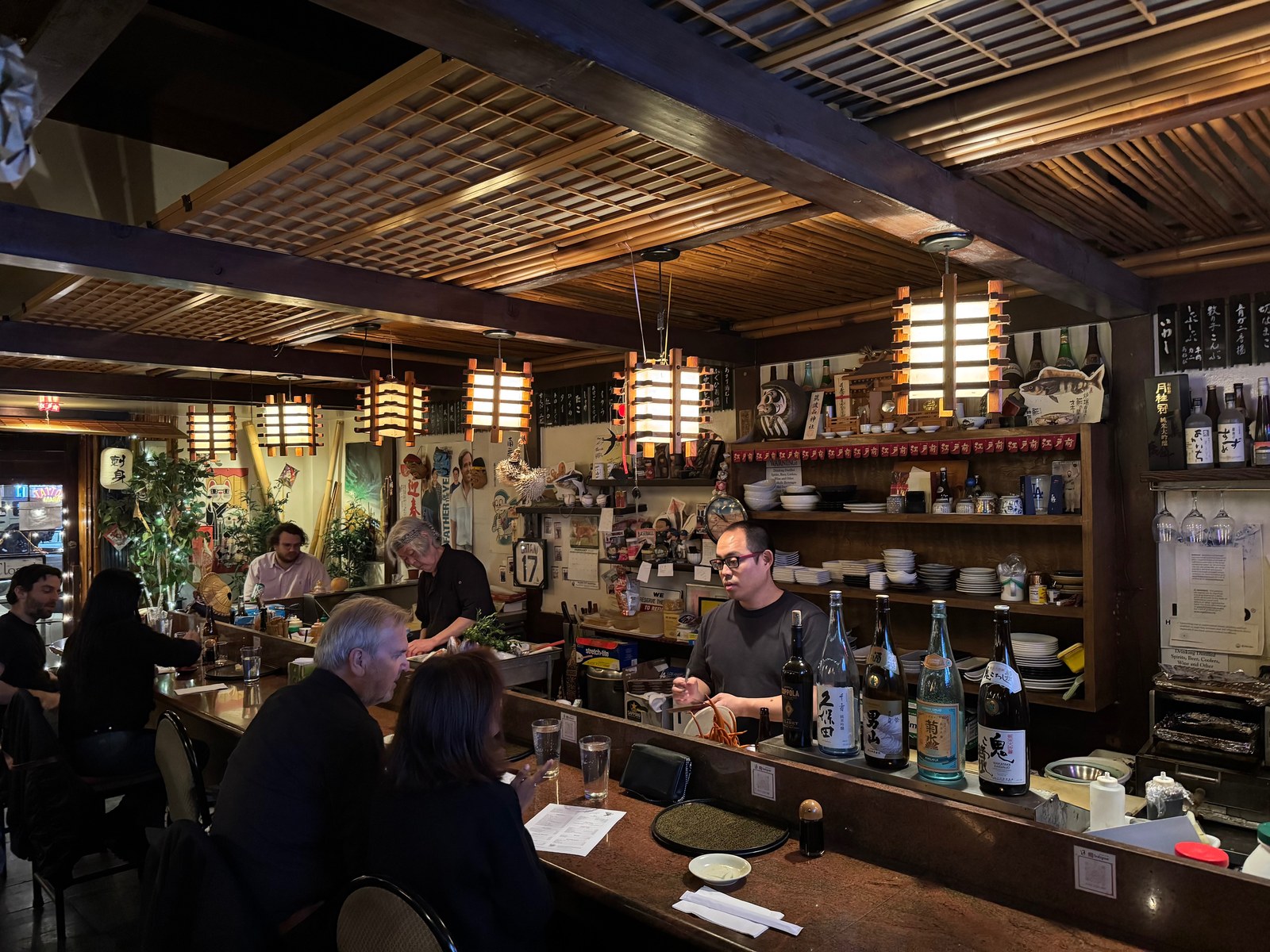 Ta-Ke Sushi traditional sushi-bar interior with lantern lighting and sake bottles