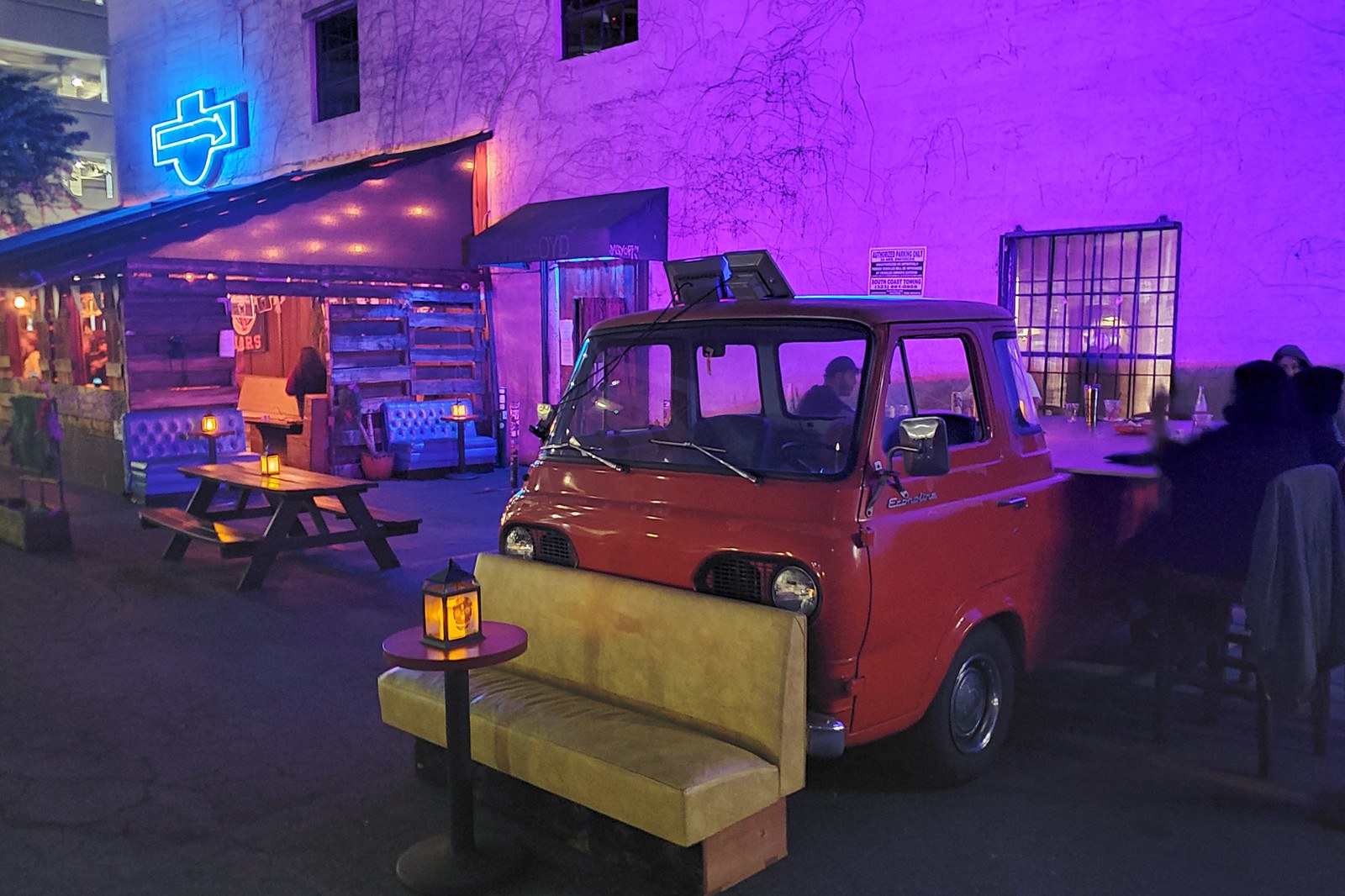 The Escondite nighttime patio with red van and neon lighting, Boyd Street DTLA