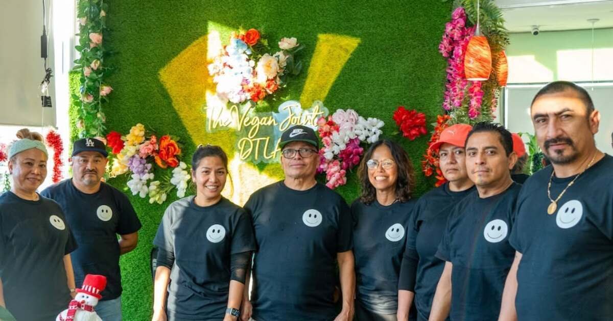 The Vegan Joint DTLA staff in front of neon signage