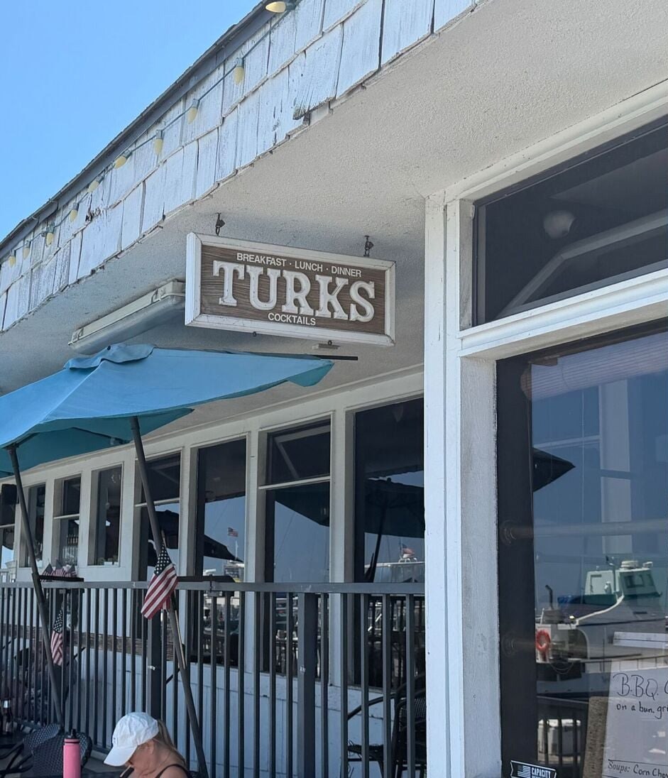 Turk’s exterior sign Breakfast Lunch Dinner Cocktails on the Dana Point Harbor Wharf patio