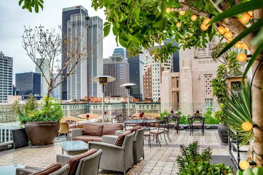 Perch rooftop patio overlooking the Downtown Los Angeles skyline, including the Aon Center